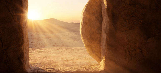 An empty cave tomb with a large stone rolled aside, revealing a bright desert sunrise.