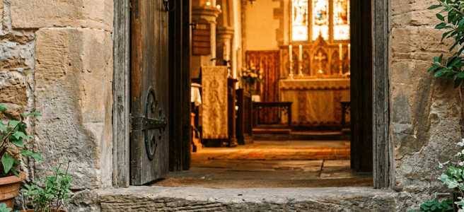 Sandals outside an open stone chapel doorway with stained glass